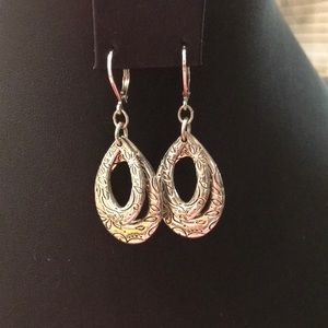 Premier Design dangle Earrings made of mixed metals with a silver tone finish.